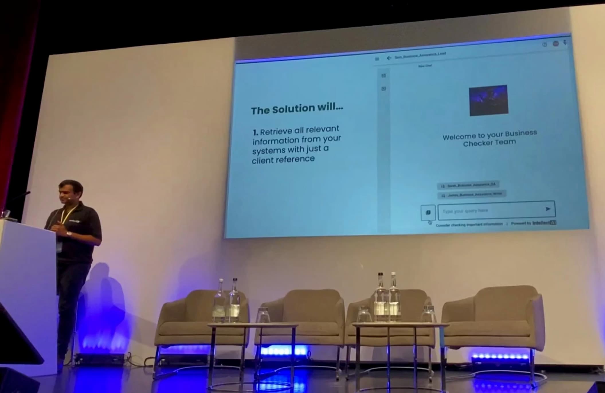 Aditya at the lectern on the FT Adviser stage, a Purple Fabric business-checker demo on the screen beside him